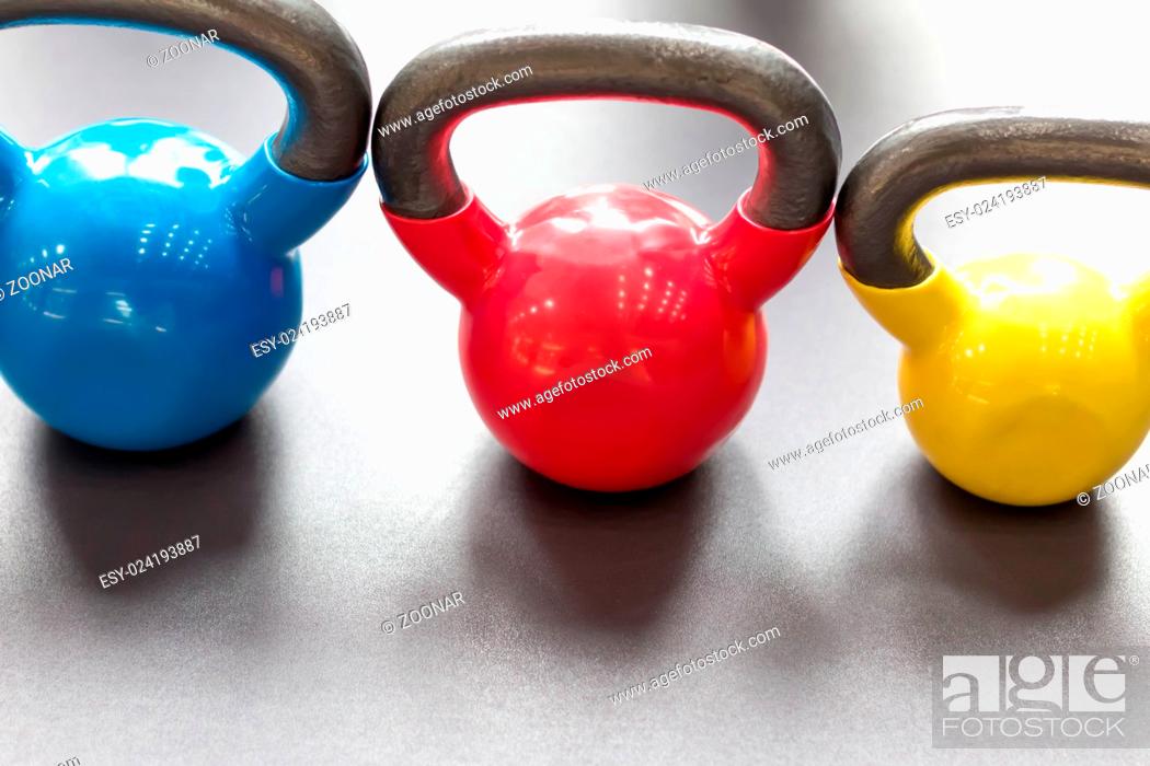 Stock Photo: colorful kettle bell on table.