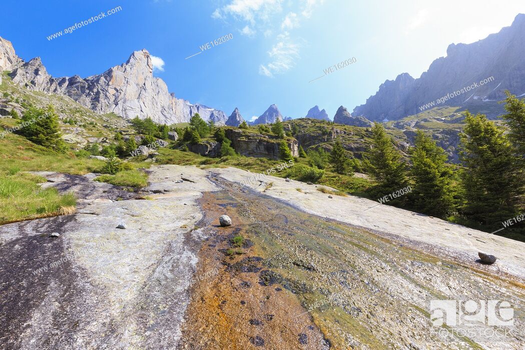 Stock Photo: A water ripple flows on a rock plain in Torrone Valley, Valmasino, Valtellina, Sondrio province, Lombardy, Italy.