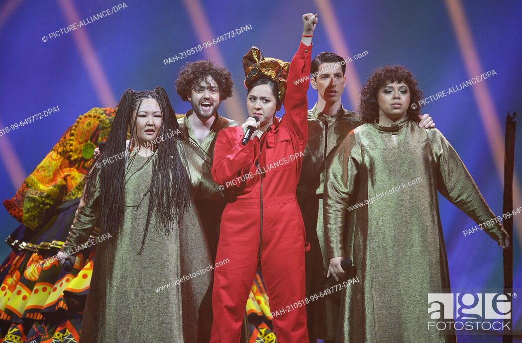 Stock Photo: 17 May 2021, Netherlands, Rotterdam: Singer Manizha (Russia) performs with her band and the song ""Russian Woman"" during the second dress rehearsal of the.