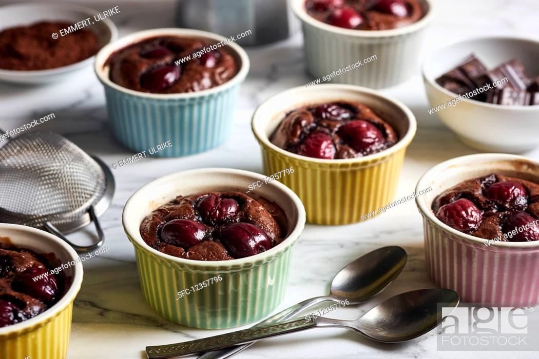 Stock Photo: Chocolate and cherry clafoutis in colourful ramekins.