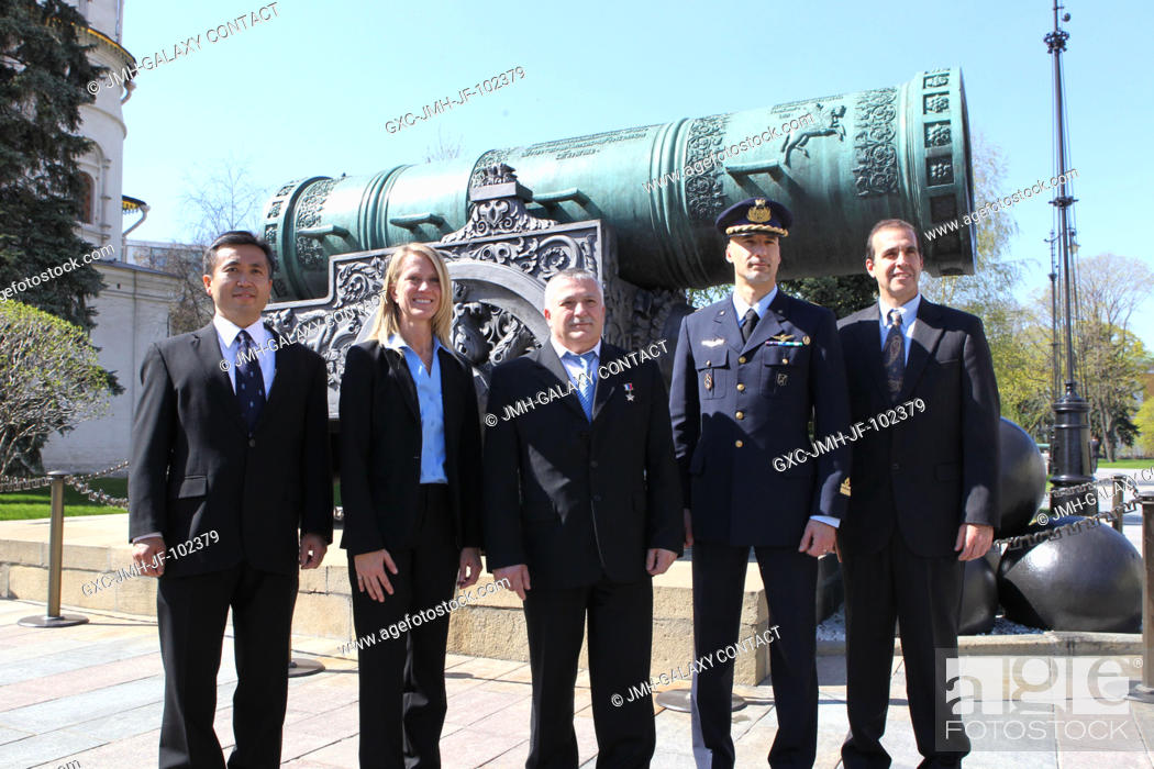 Stock Photo: Expedition 3637 prime and backup crew members pose for pictures in front of the Tsar Cannon at the Kremlin during a traditional tour of Red Square and the.