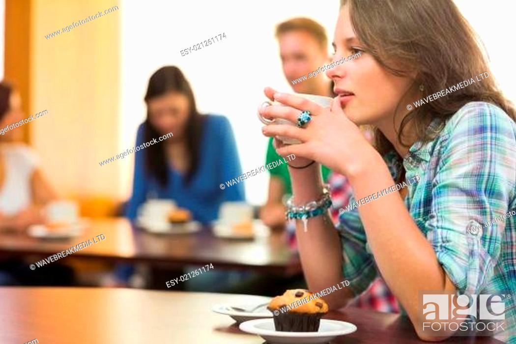 Stock Photo: Female having coffee and muffin at coffee shop.