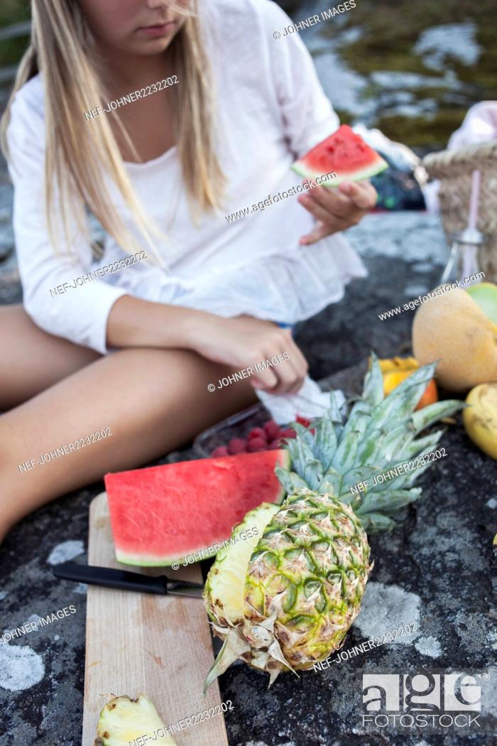 Stock Photo: Girl cutting fruits.