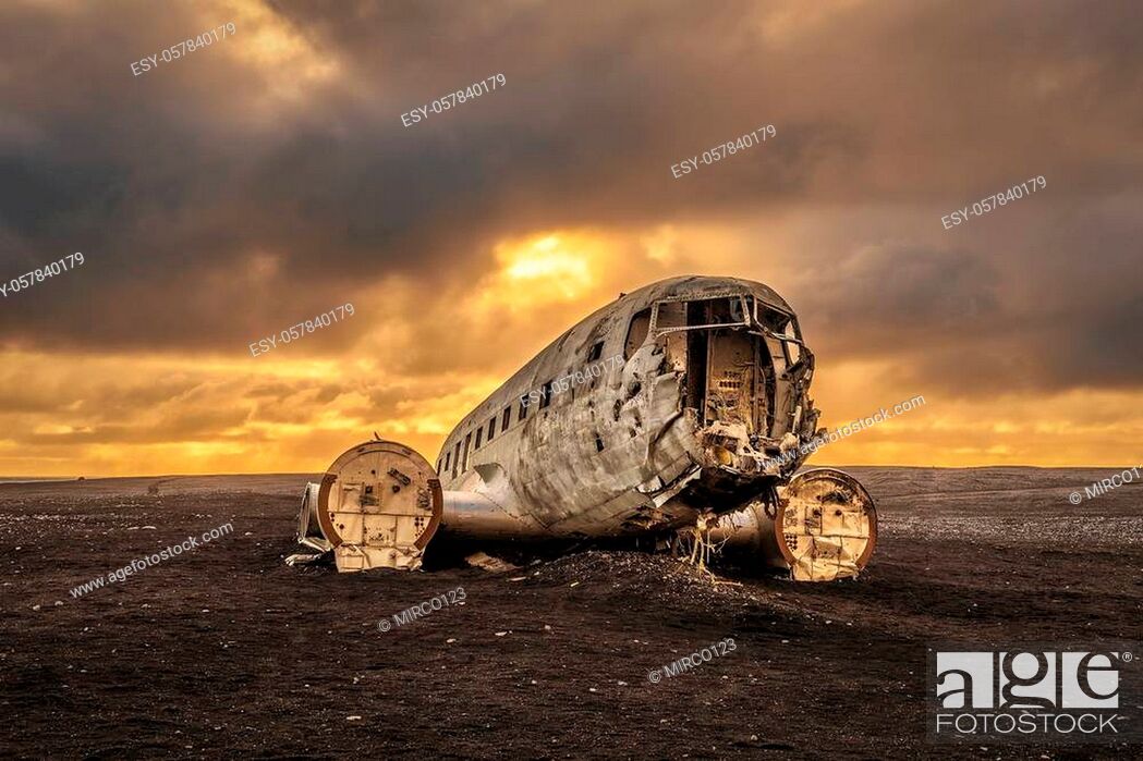 Stock Photo: Old crashed plane abandoned on Solheimasandur beach near Vik in Iceland with heavy storm clouds in the sky. Hdr processed.
