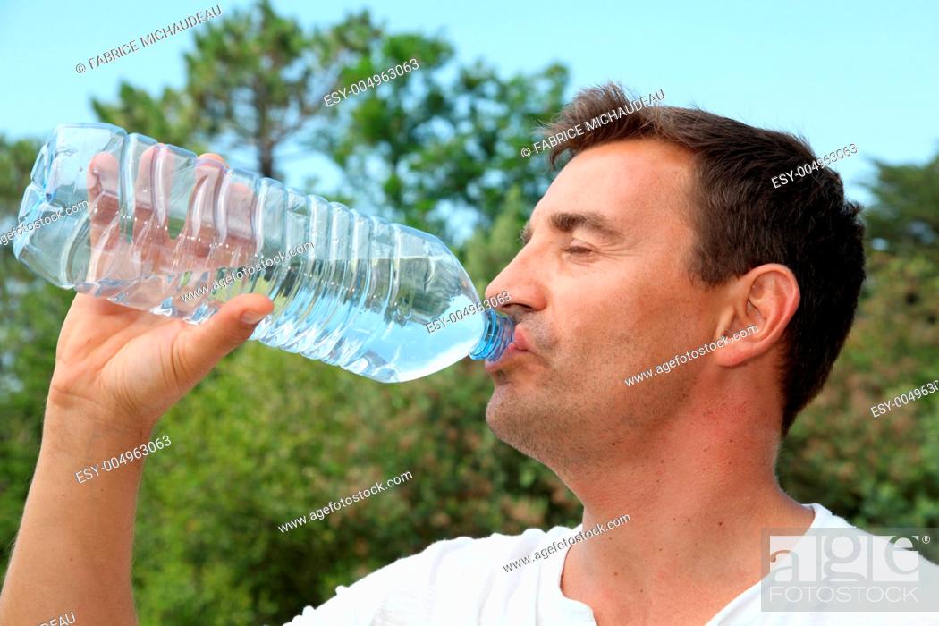 Stock Photo: Man drinking water from bottle.