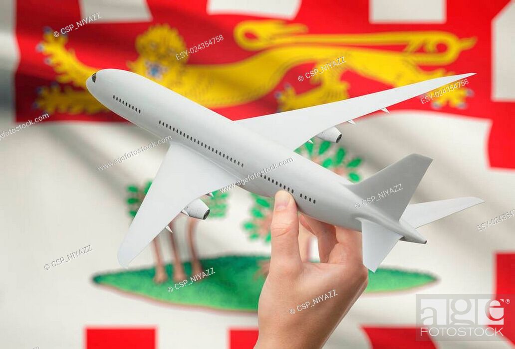 Stock Photo: Airplane in hand with Canadian province flag on background - Prince Edward Island.