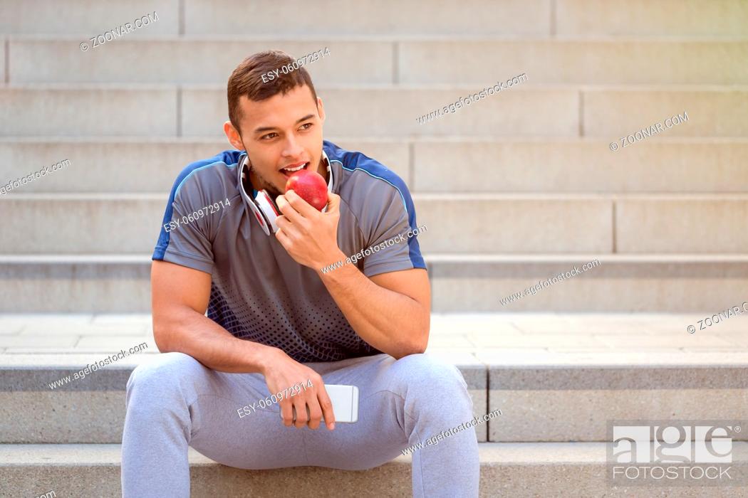 Stock Photo: Eating apple fruit runner young man copyspace copy space sports training fitness outdoor.