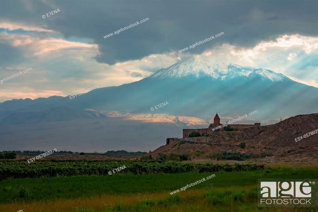 Stock Photo: Khor Virap monastery on the background of mount Ararat. Sunset landscape with clouds and sunshine. Armenia.