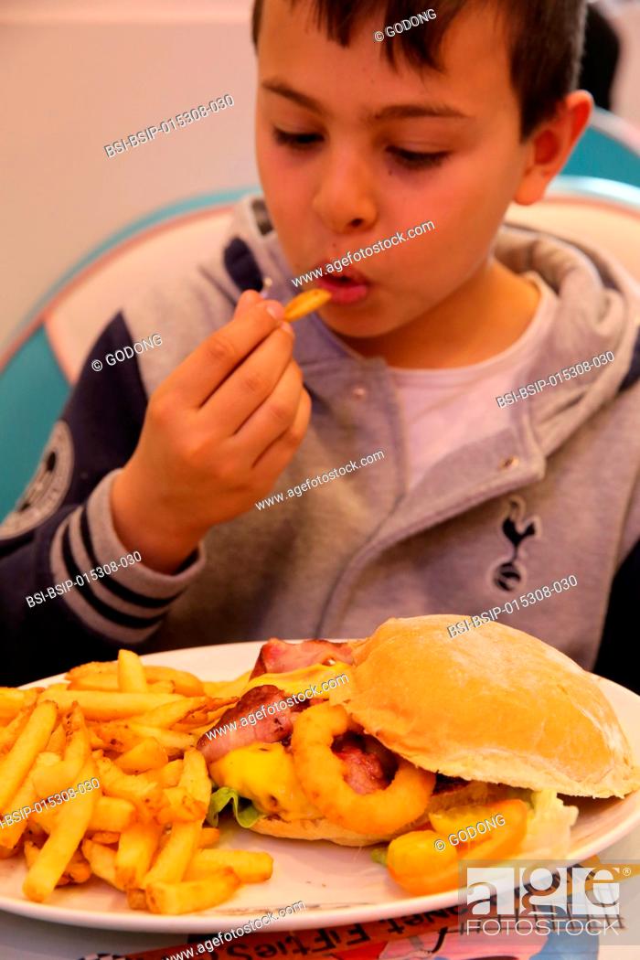 Stock Photo: 10-year-old boy in a restaurant.