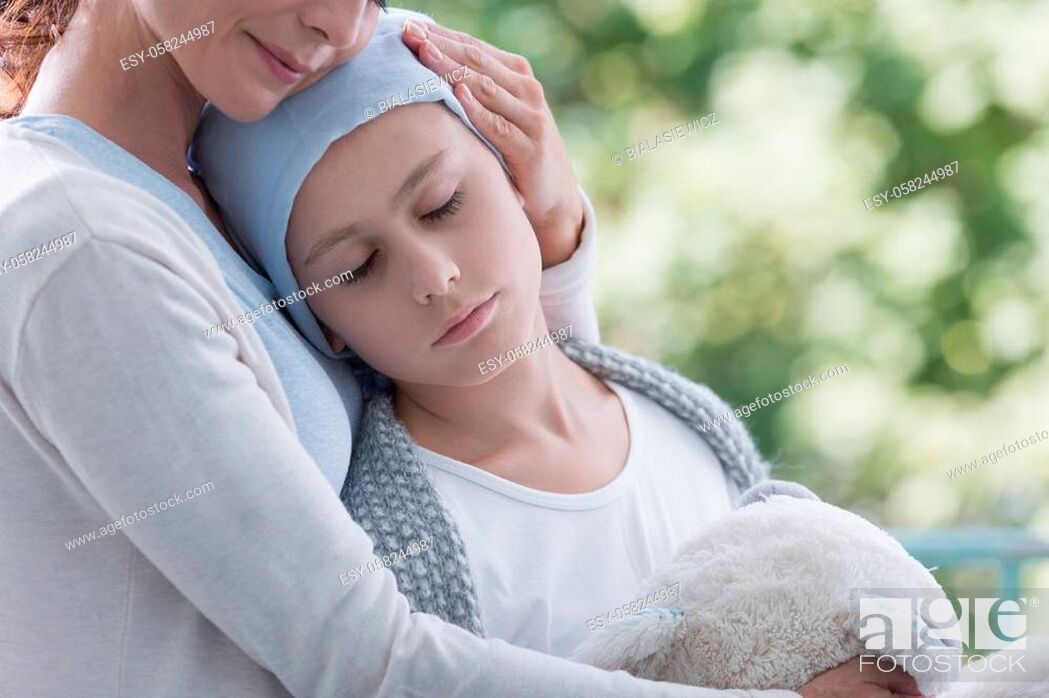 Stock Photo: Mother and sick teenager daughter with cancer in the garden of home hospice.