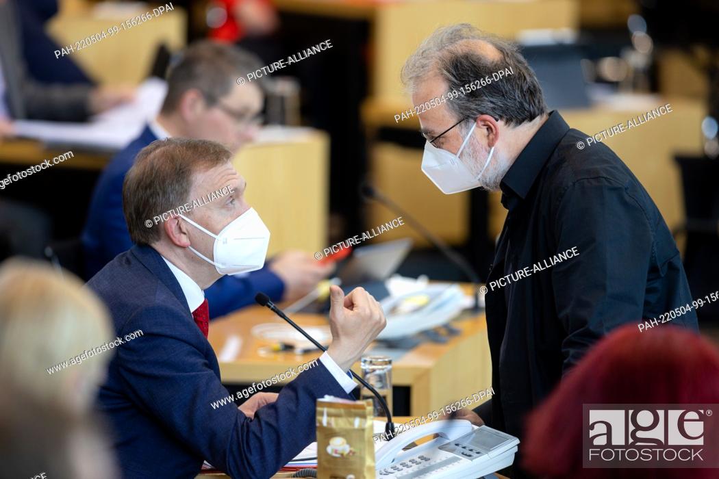 Stock Photo: 04 May 2022, Thuringia, Erfurt: Parliamentary group leaders Matthias Hey (l, SPD) and Steffen Dittes (Die Linke) talk to each other during the Thuringian state.