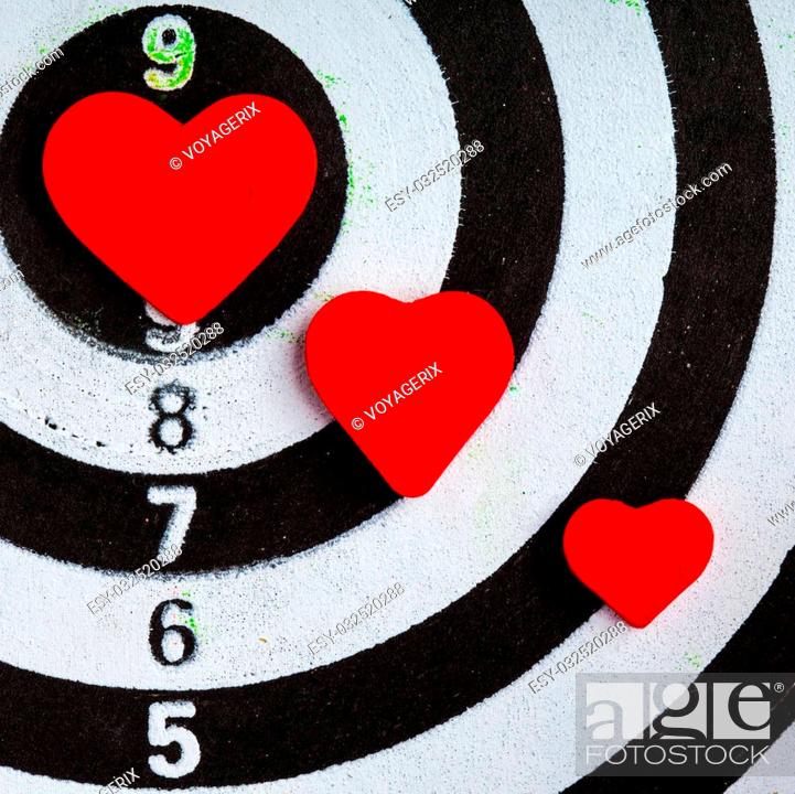 Stock Photo: Closeup of old black and white target with red hearts symbols bullseye as love background. Valentines day.