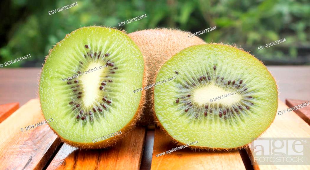Stock Photo: sliced kiwifruit on wooden board.