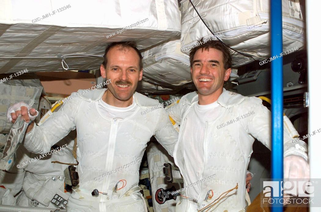 Stock Photo: Astronauts Steven L. Smith (left) and Rex J. Walheim, both STS-110 mission specialists, are photographed on the International Space Station (ISS) after the.