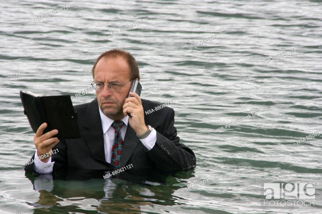 Stock Photo: manager stands in deep water.