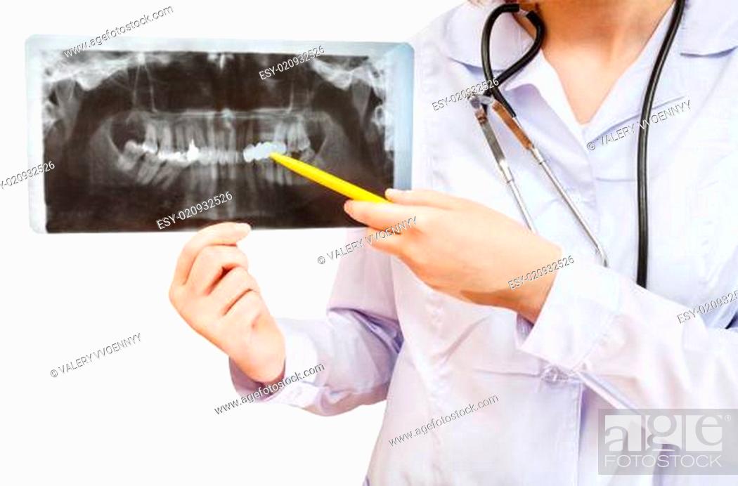 Stock Photo: nurse points on X-ray picture with human jaw.