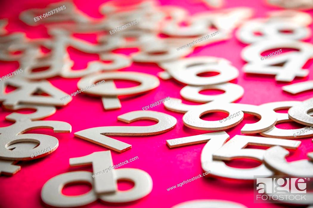 Stock Photo: Mathematics background made with solid numbers on a board. Isolated on pink.