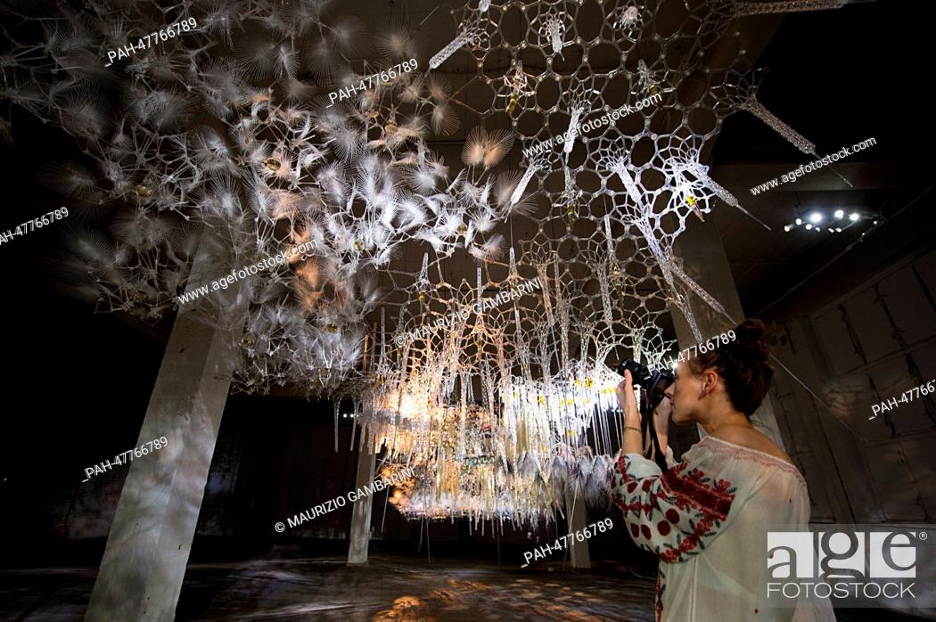 Stock Photo: A visitor takes pictures of the installation 'Epiphyte Membrane' of the artist Philip Beesley during the exhibition project 'Photography Playground' in the.