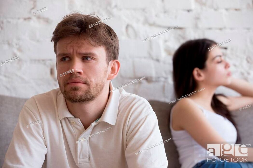 Stock Photo: Upset millennial man think about relationship problems, having fight with proud female lover, offended couple not talking after family quarrel.
