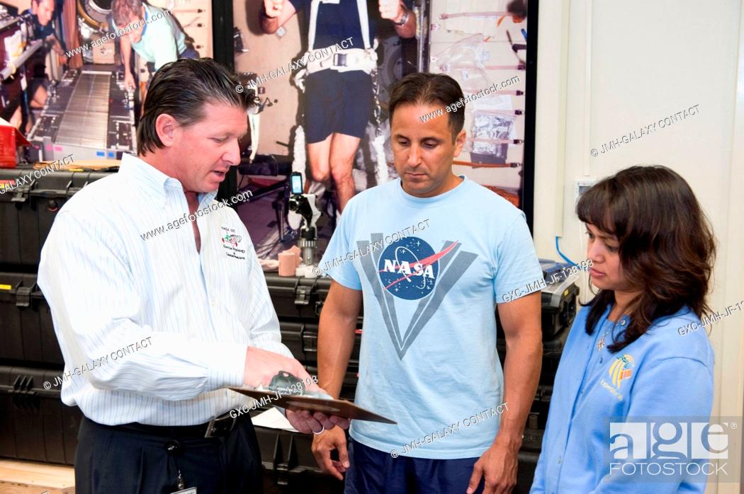 Stock Photo: NASA astronaut Joe Acaba (center), Expedition 3132 flight engineer, participates in a treadmill kinematics baseline data collection session in the Planetary and.