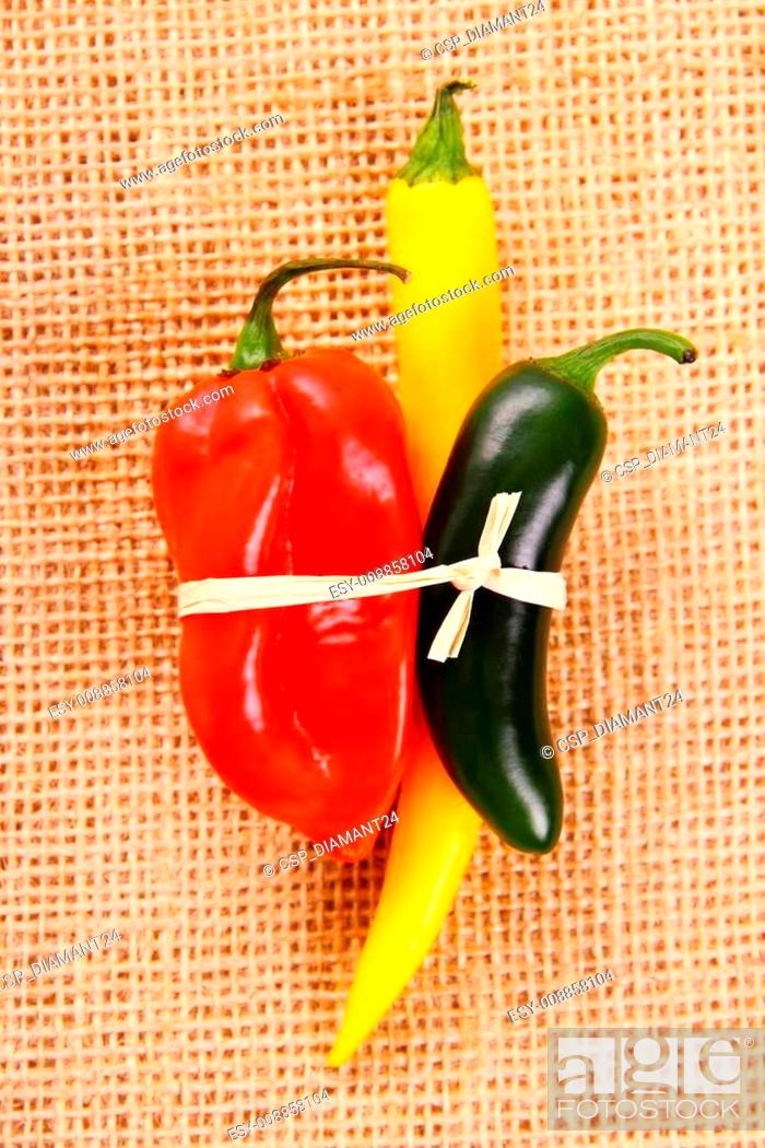 Stock Photo: Bundle of Hot pepper varieties of jute background.