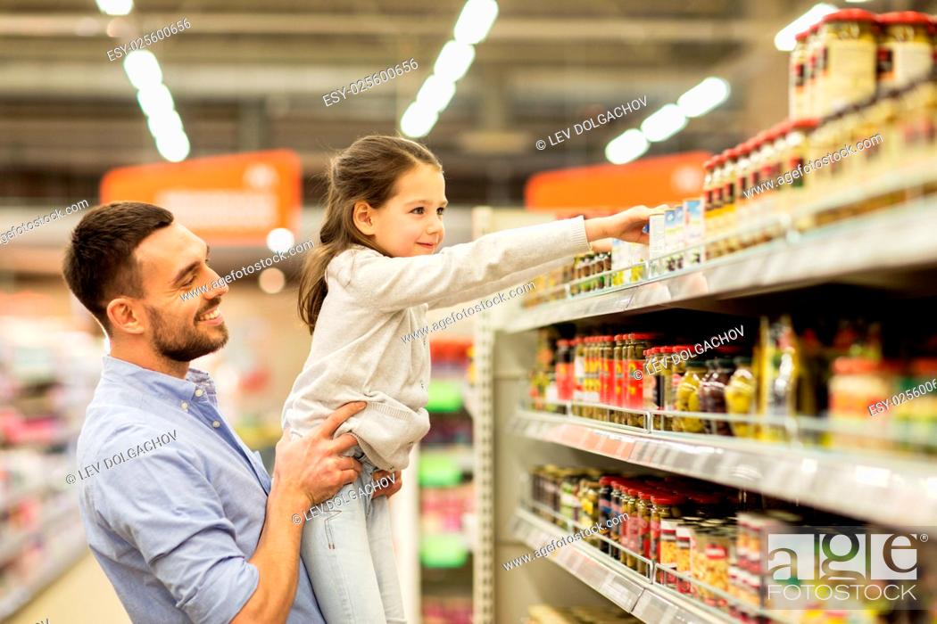 Stock Photo: family, sale, shopping, consumerism and people concept - happy father with child buying food at grocery store.