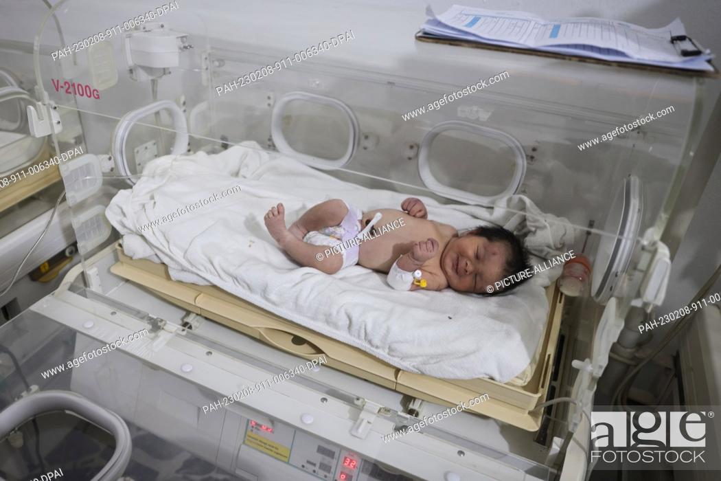 Stock Photo: 08 February 2023, Syria, Afrin: A newborn girl lies inside an incubator as part of her medical checkup at a children's hospital in the Syrian town of Afrin.