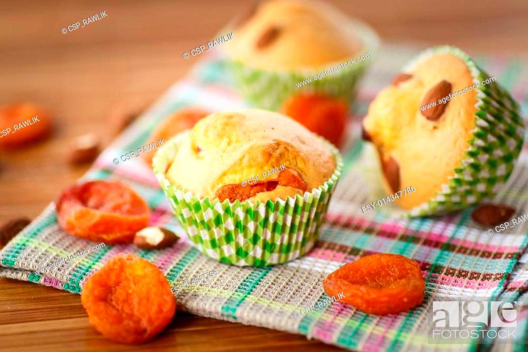 Stock Photo: muffins with almonds and dried apricots.