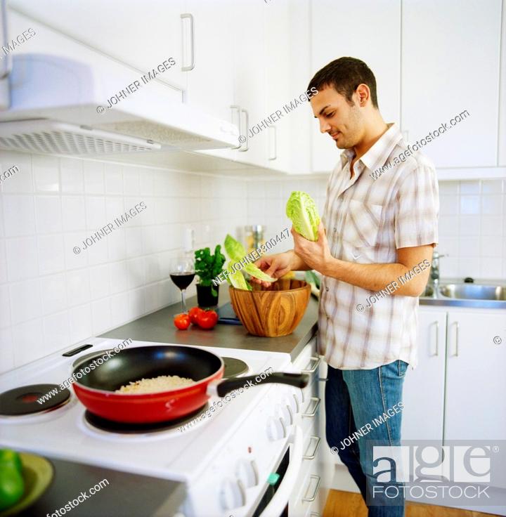 Stock Photo: A man cooking in a kitchen.