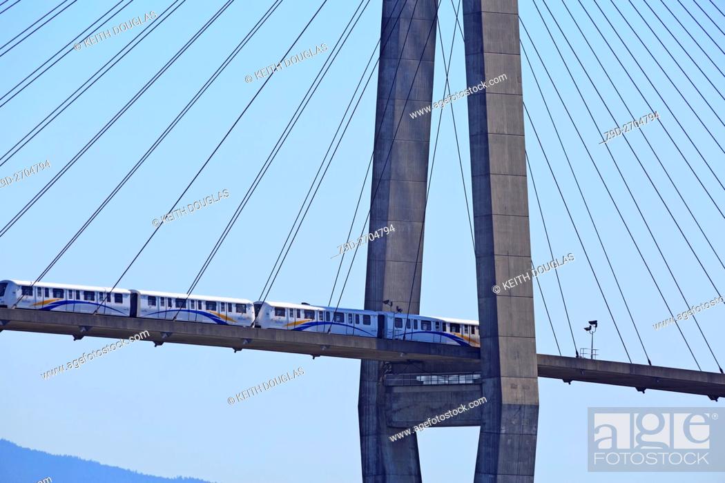 Stock Photo: Skytrain Rapid transit bridge crossing the Fraser River from new Westminster to Surrey, British Columbia.