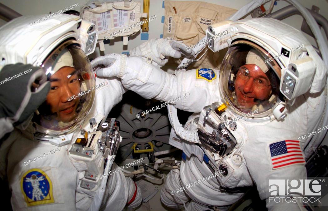 Stock Photo: Astronauts Soichi Noguchi (left) representing the Japan Aerospace Exploration Agency (JAXA), and Stephen K. Robinson, both STS-114 mission specialists.