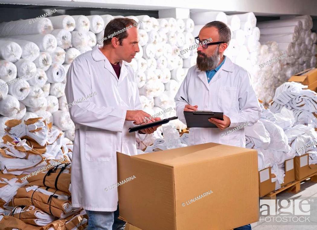 Stock Photo: warehouse supervisor and manager men in fashion textile factory.