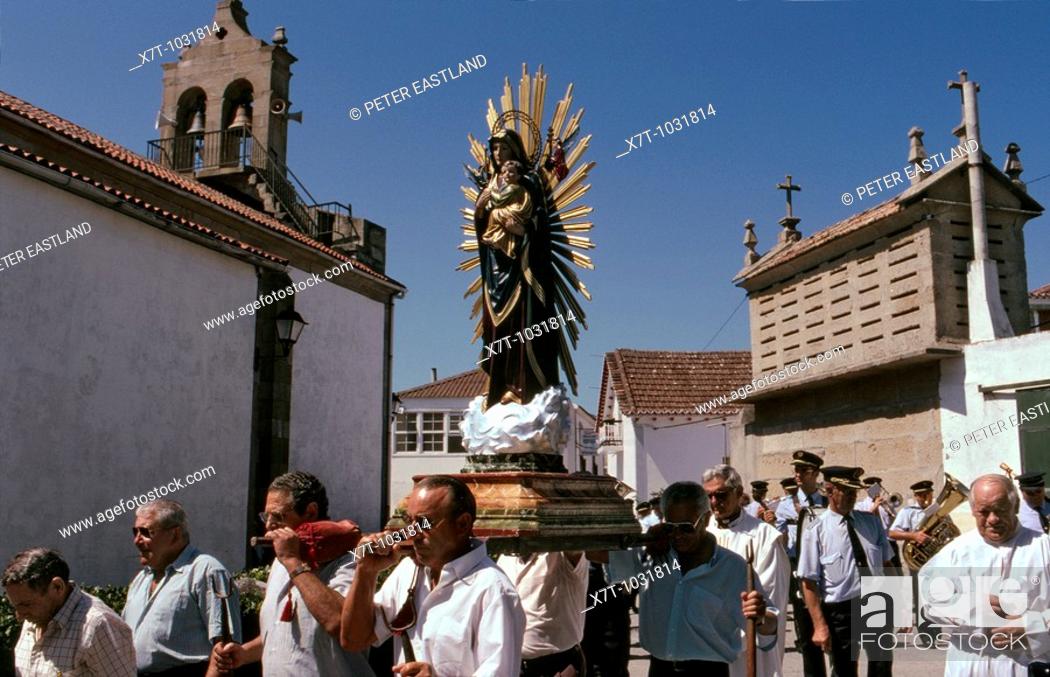 Stock Photo: Local fishermen and vilagers parade their patron saint around the village of Corrubedo during a Summer religious festival  La Coruna Province, Galicia,.