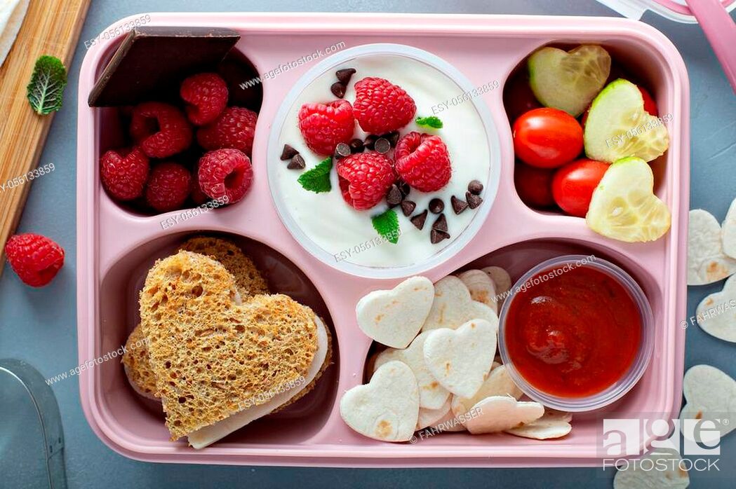 Stock Photo: Valentines day lunch for kids with heart shaped sandwich.
