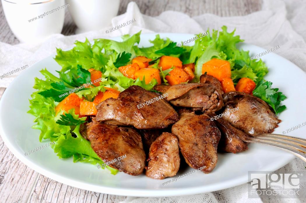 Stock Photo: Fried chicken liver with vegetable garnish, baked pumpkin in lettuce leaves.