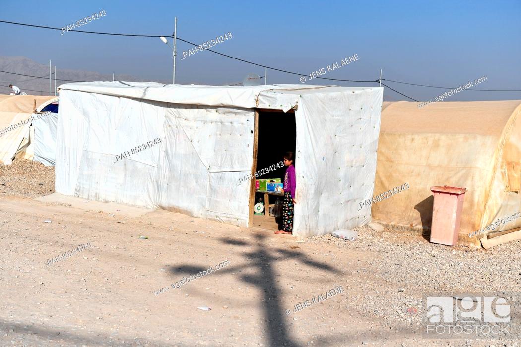 Stock Photo: A girl stands in a tent where one can buy groceries in the Mamilian refugee camp in the Dohuk region, Iraq, 19 October 2016.
