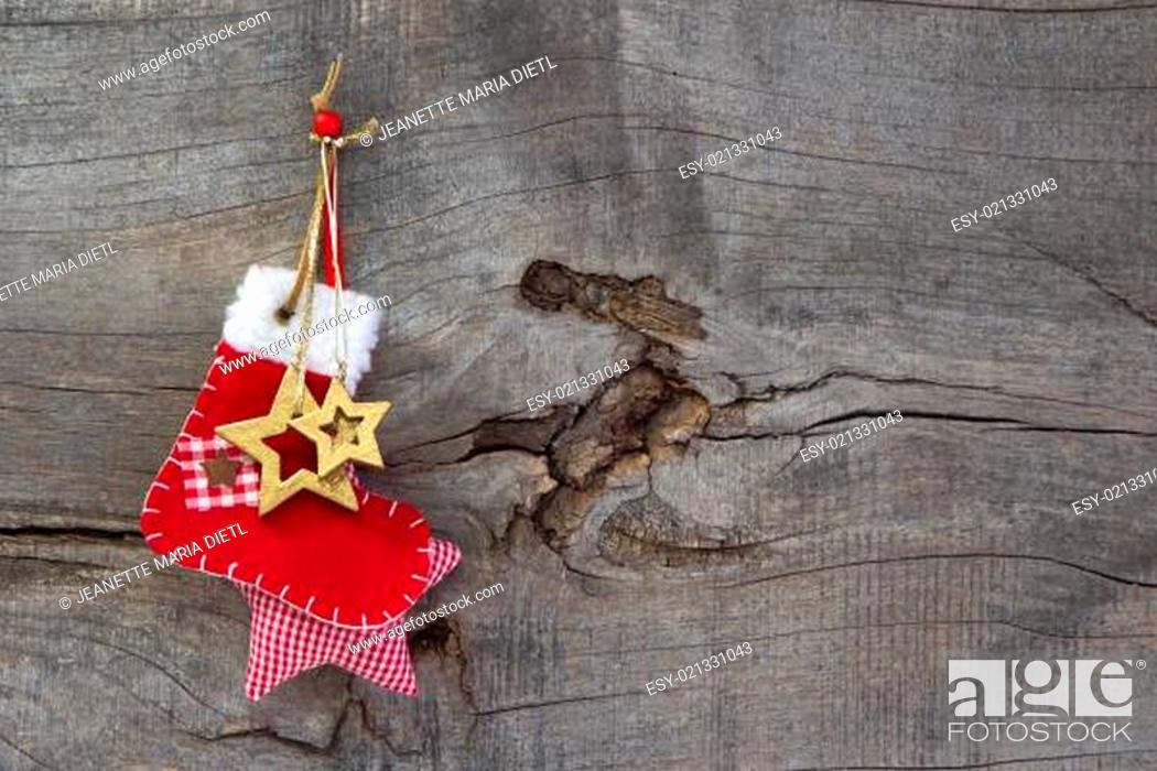 Stock Photo: Red christmas or santa boot on a wooden old shabby country style background.