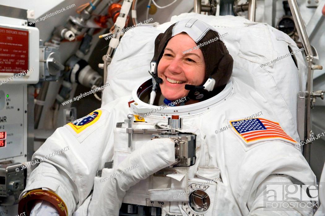 Stock Photo: NASA astronaut Catherine Coleman, Expedition 2627 flight engineer, participates in an Extravehicular Mobility Unit (EMU) spacesuit fit check in the Space.