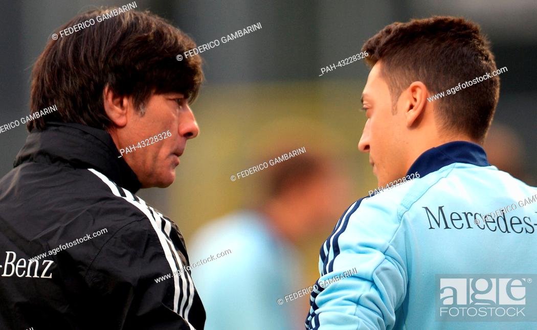 Stock Photo: Germany's head coach Joachim Loew (L) chats with his player Mesut Oezil during the training session of the German national soccer team in Duesseldorf, Germany.