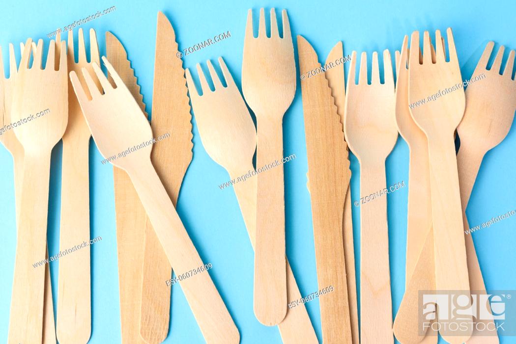 Stock Photo: wooden forks and knives on a blue background, zero waste.