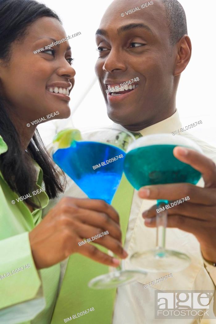 Stock Photo: Hispanic couple holding cocktails.