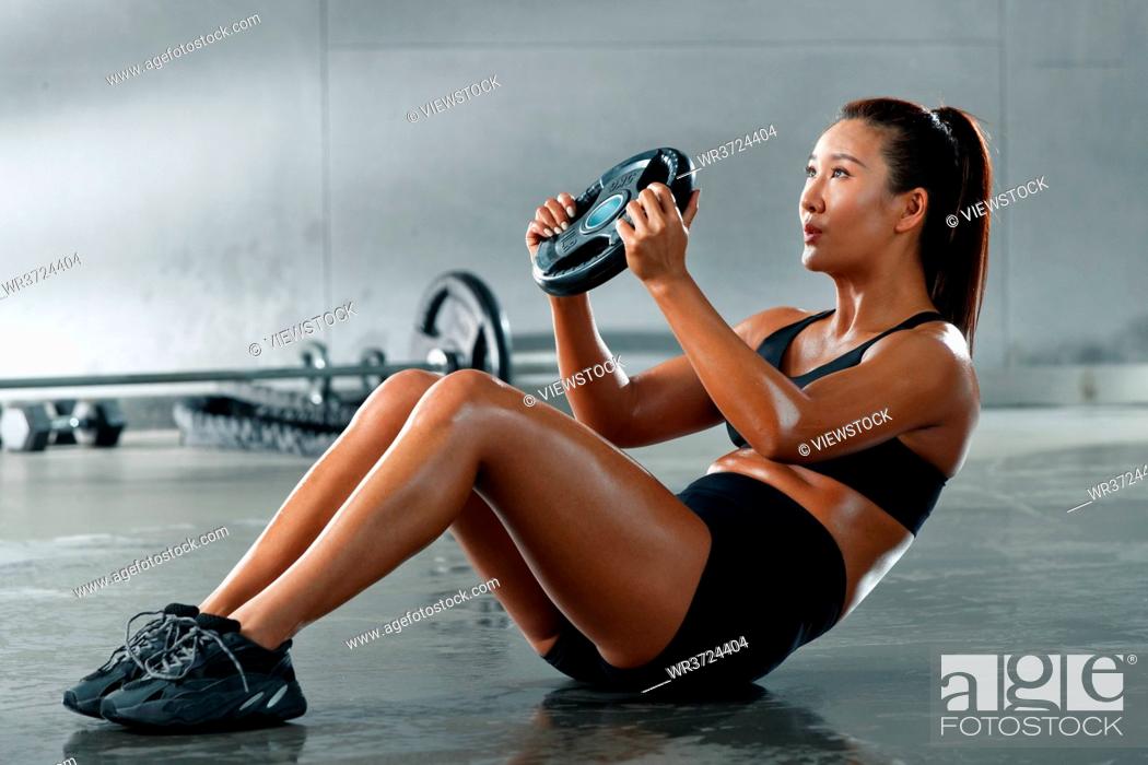 Stock Photo: Young women in the gym training.
