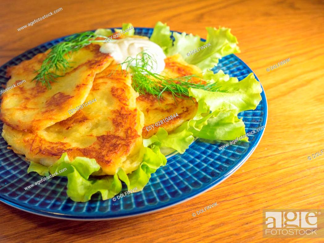 Stock Photo: potato pankakes with cream frache and dill - draniki.