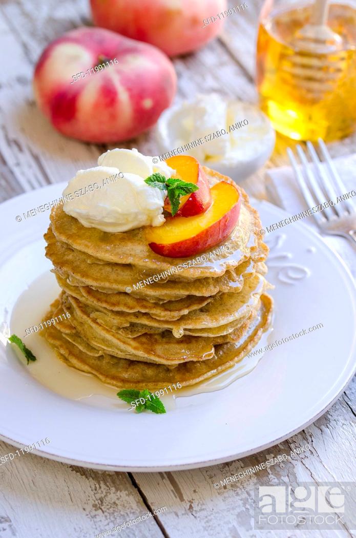 Stock Photo: Pancakes with peach, cream cheese and honey.