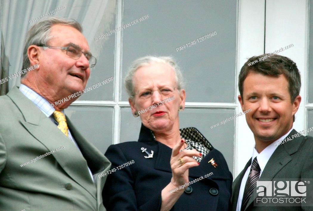 Stock Photo: Crown Prince Frederik of Denmark (R), his mother Queen Margrethe II of Denmark (C) and his father Henrik, Prince Consort of Denmark (L) smile from the balcony.