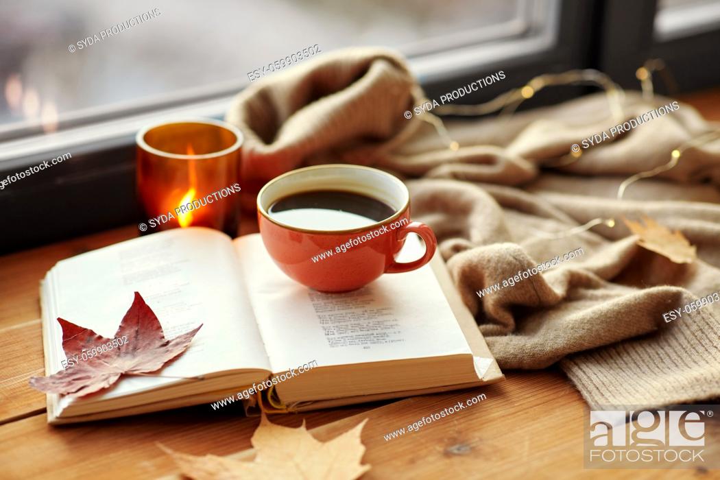 Stock Photo: cup of coffee, book on window sill in autumn.
