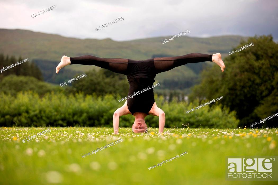 Maryanne Jones bed esthetisch Mature woman practicing yoga standing on head with legs open in field,  Stock Photo, Picture And Royalty Free Image. Pic. CUL-IS09AS6RQ |  agefotostock