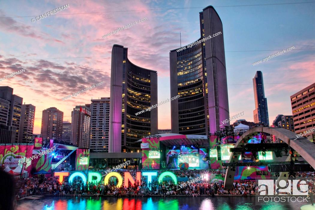 Stock Photo: CANADA, TORONTO, 20.07.2015, Hundreds of people enjoy an open air concert during Panamania at Nathan Phillips Square by the Toronto City Hall building to.