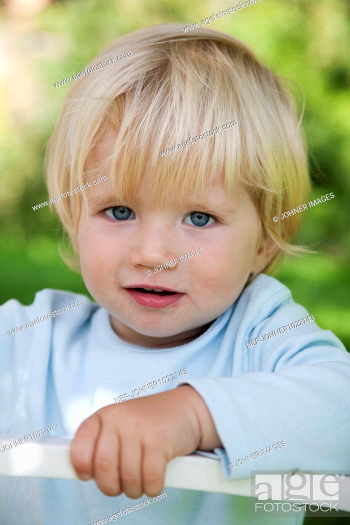 Photo de stock: Portrait of blonde boy outdoors.