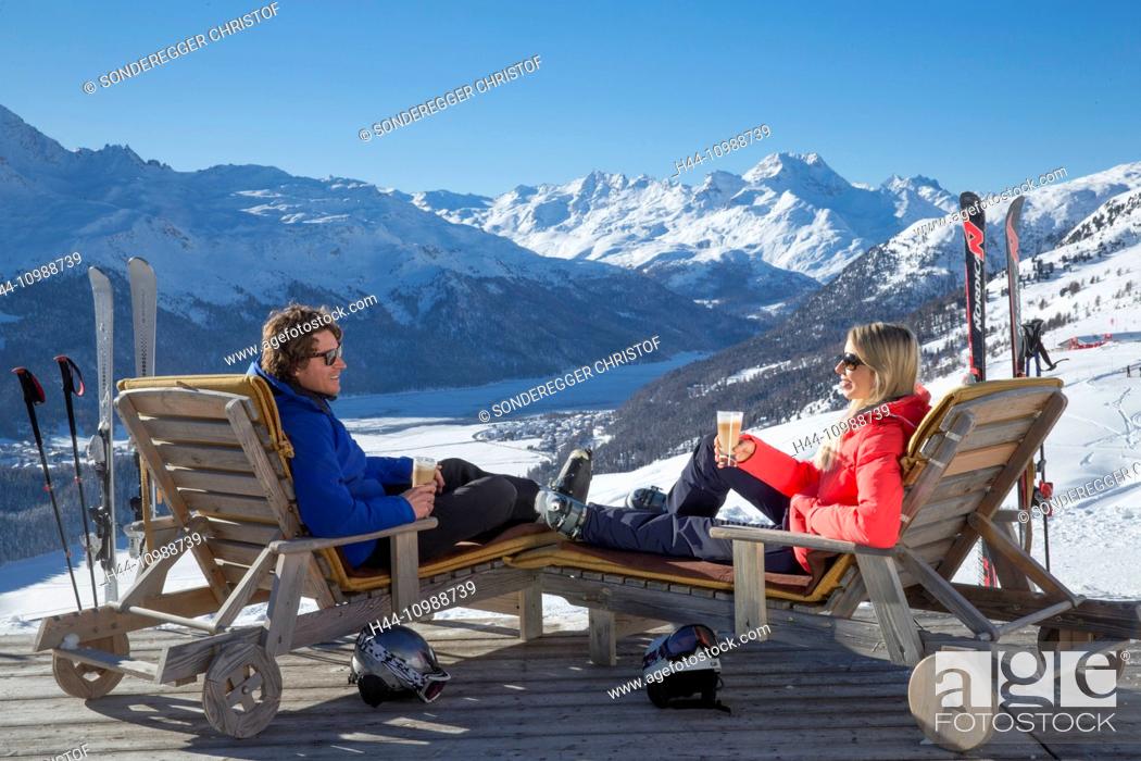 Stock Photo: Couple in deck chairs in mountain restaurant Trutz, Engadine,.